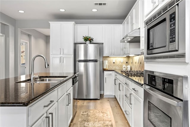 341 W Pebble Creek Ln, Orange, CA 92865 - kitchen with appliances with stainless steel finishes, a sink, light wood-style flooring, white cabinetry, and recessed lighting