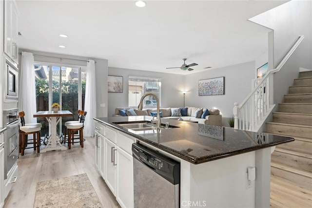 341 W Pebble Creek Ln, Orange, CA 92865 - kitchen with stainless steel appliances, a sink, a kitchen island with sink, white cabinets, and recessed lighting