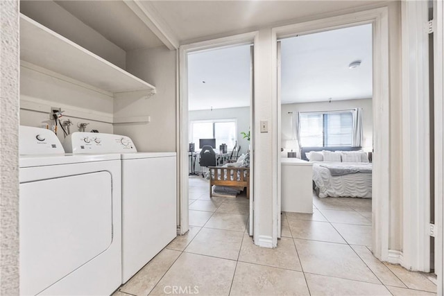 9038 Orion Ave Unit 107, North Hills, CA 91343 - washroom with independent washer and dryer and light tile patterned flooring