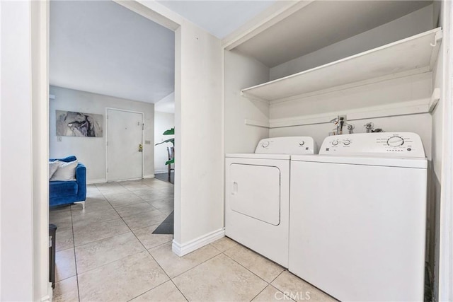9038 Orion Ave Unit 107, North Hills, CA 91343 - laundry room with separate washer and dryer, light tile patterned floors, and baseboards
