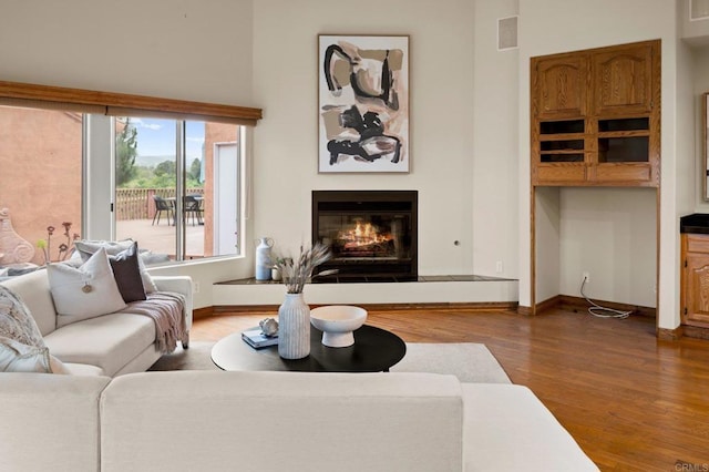 4036 Stonebridge Ln, Rancho Santa Fe, CA 92091 - living area featuring a glass covered fireplace, wood finished floors, and baseboards