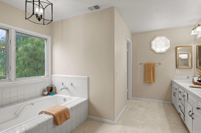 4036 Stonebridge Ln, Rancho Santa Fe, CA 92091 - bathroom with double vanity, a garden tub, a chandelier, and baseboards