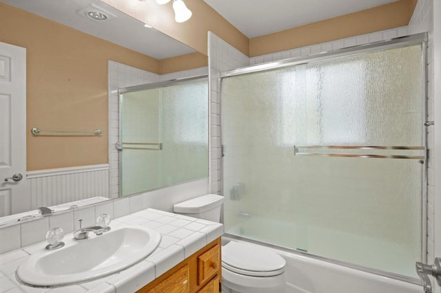 4036 Stonebridge Ln, Rancho Santa Fe, CA 92091 - full bathroom featuring toilet, vanity, enclosed tub / shower combo, and wainscoting