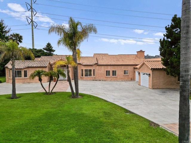 4036 Stonebridge Ln, Rancho Santa Fe, CA 92091 - mediterranean / spanish-style house with concrete driveway, a chimney, stucco siding, a tiled roof, and a front yard