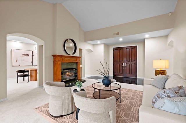 4036 Stonebridge Ln, Rancho Santa Fe, CA 92091 - carpeted living area featuring arched walkways, high vaulted ceiling, a glass covered fireplace, baseboards, and recessed lighting