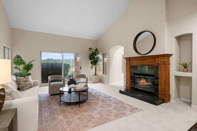 4036 Stonebridge Ln, Rancho Santa Fe, CA 92091 - carpeted living area featuring high vaulted ceiling, a glass covered fireplace, and baseboards