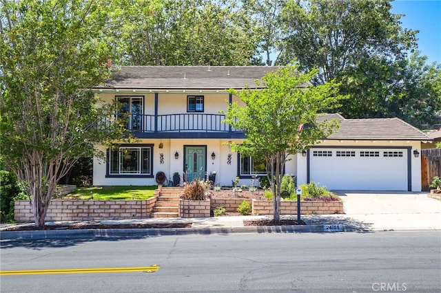 24751 Mosquero Ln, Mission Viejo, CA 92691 - view of front of property with a balcony, stucco siding, an attached garage, and driveway