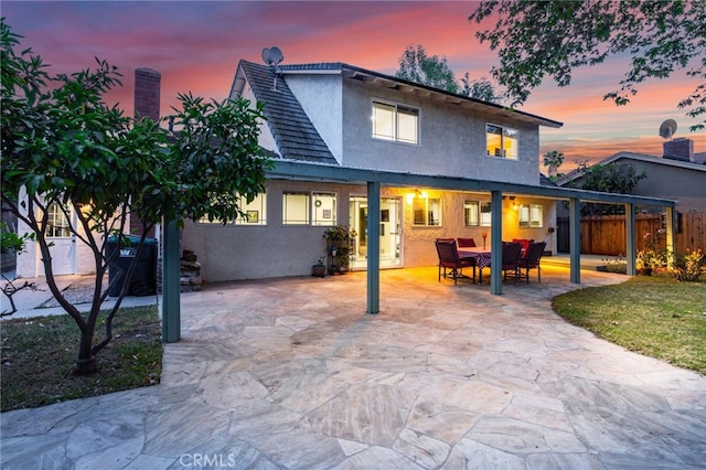 24751 Mosquero Ln, Mission Viejo, CA 92691 - back of house at dusk with stucco siding and a patio