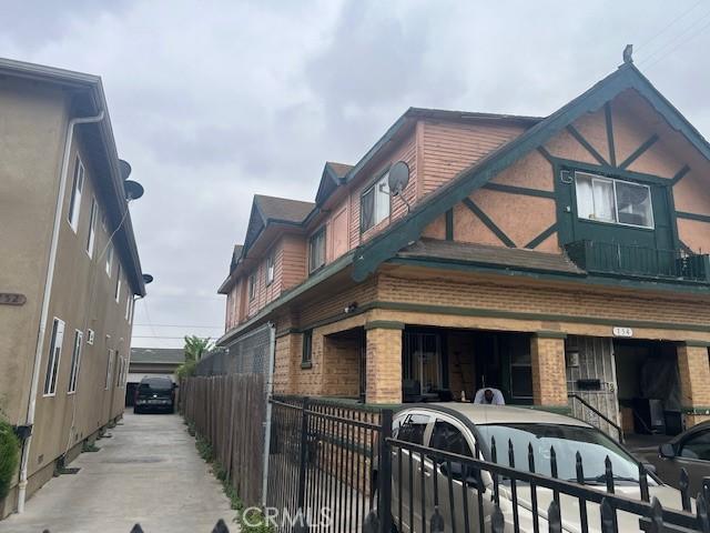154 W 59th Pl, Los Angeles, CA 90003 - view of property exterior with brick siding and a garage