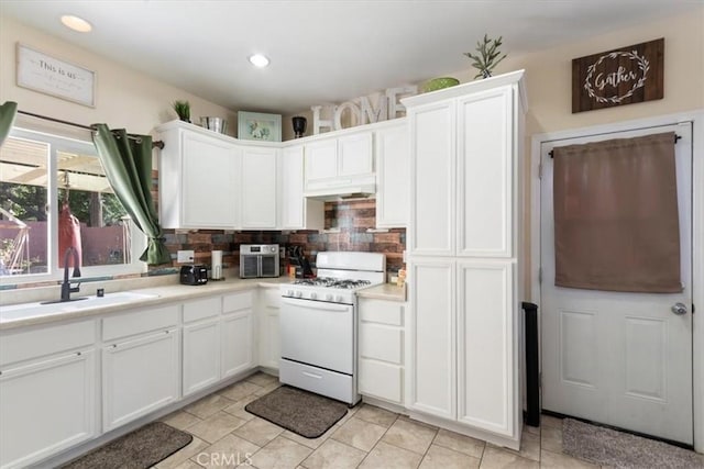 350 E Nugent St, Lancaster, CA 93535 - kitchen featuring gas range gas stove, a sink, under cabinet range hood, white cabinets, and recessed lighting