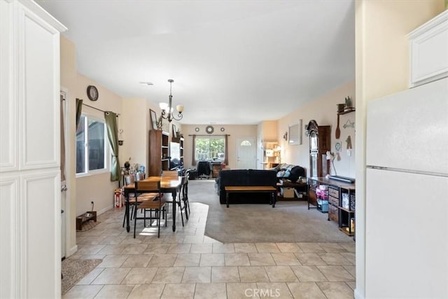 350 E Nugent St, Lancaster, CA 93535 - dining room with a chandelier, light colored carpet, and light tile patterned floors