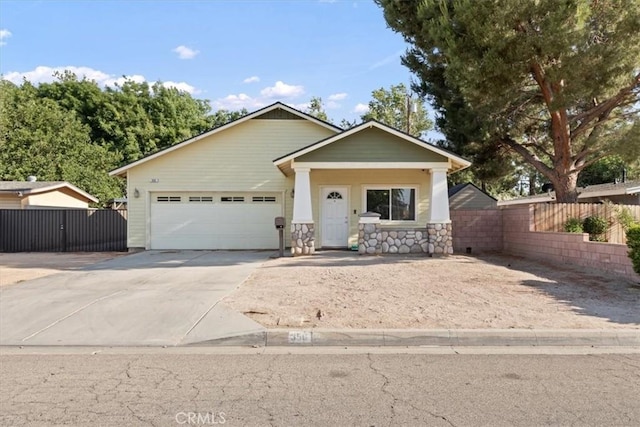 350 E Nugent St, Lancaster, CA 93535 - view of front of house featuring concrete driveway, a garage, and stone siding