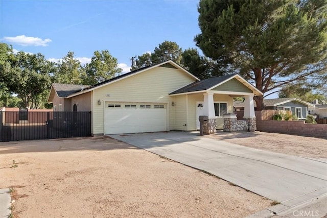 350 E Nugent St, Lancaster, CA 93535 - view of front facade featuring an attached garage, driveway, a porch, and a gate