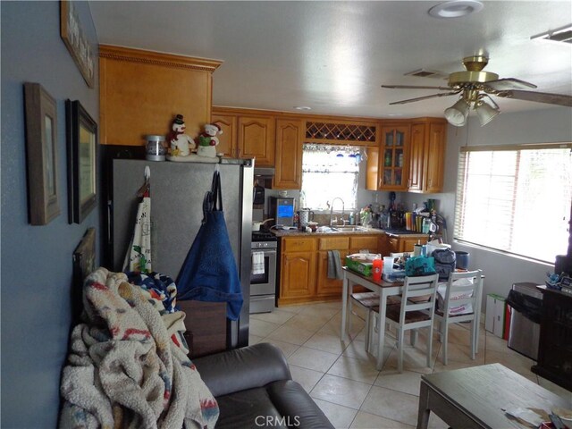 1908 Bailey Ave, Rosemead, CA 91770 - kitchen with brown cabinetry, a ceiling fan, light tile patterned floors, and a sink