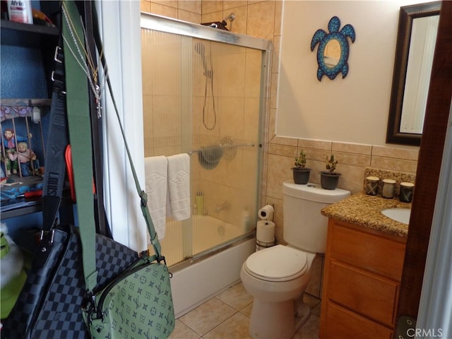 1908 Bailey Ave, Rosemead, CA 91770 - bathroom with combined bath / shower with glass door, vanity, toilet, tile walls, and tile patterned floors