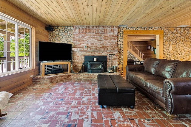 3537 Pinon Pines Rd, Wrightwood, CA 92397 - living room with wooden ceiling, wooden walls, stairs, brick patterned floors, and a wood stove