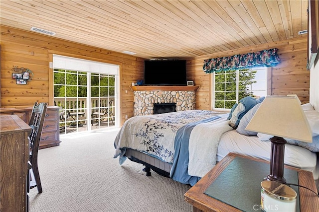 3537 Pinon Pines Rd, Wrightwood, CA 92397 - carpeted bedroom with wooden walls, multiple windows, wooden ceiling, and a stone fireplace