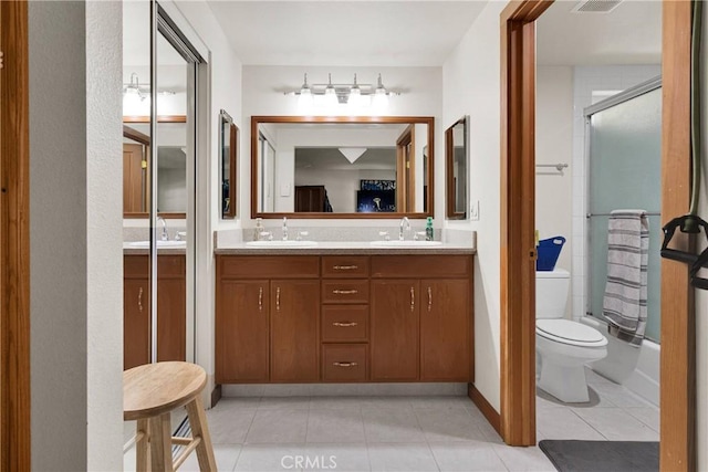 3537 Pinon Pines Rd, Wrightwood, CA 92397 - full bathroom featuring double vanity, tile patterned floors, combined bath / shower with glass door, and toilet