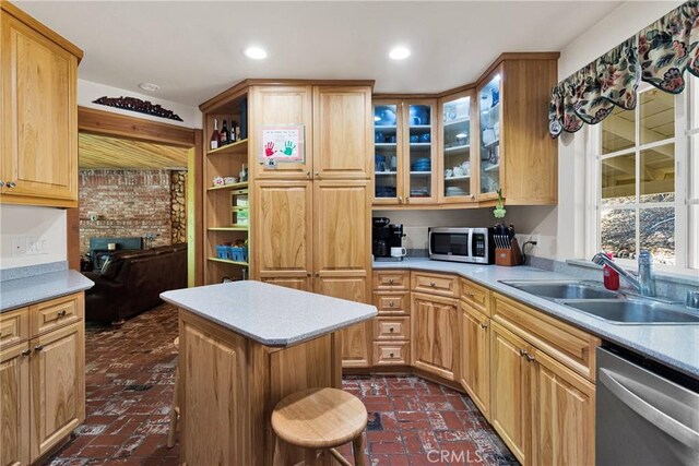 3537 Pinon Pines Rd, Wrightwood, CA 92397 - kitchen with appliances with stainless steel finishes, a sink, light countertops, brick flooring, and a kitchen island