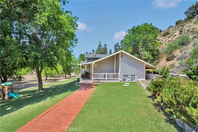 3537 Pinon Pines Rd, Wrightwood, CA 92397 - rear view of property with a porch, a lawn, and a chimney