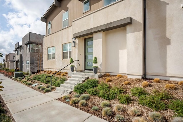 15820 Caterpillar Dr, Fontana, CA 92336 - doorway to property featuring stucco siding and central air condition unit