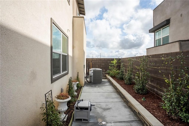 15820 Caterpillar Dr, Fontana, CA 92336 - fenced backyard featuring cooling unit and a patio area