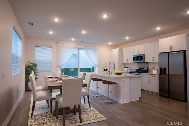 15820 Caterpillar Dr, Fontana, CA 92336 - dining area featuring healthy amount of natural light, dark wood-style flooring, baseboards, and recessed lighting