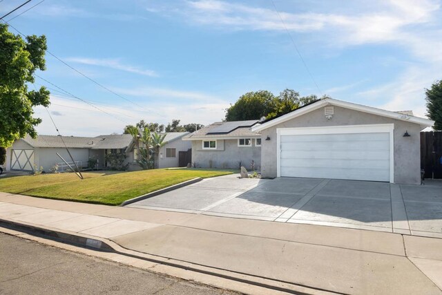 4158 Seri St, San Diego, CA 92117 - ranch-style house with roof mounted solar panels, a front yard, driveway, stucco siding, and an attached garage