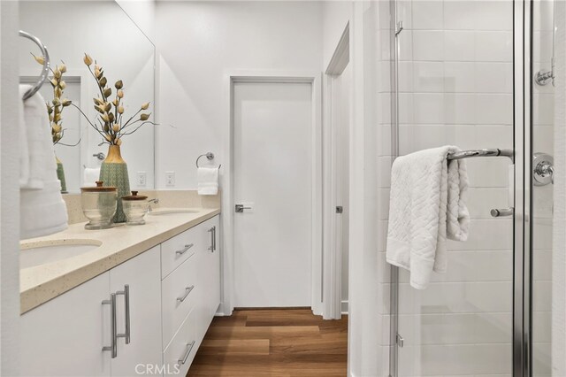 1914 W Bushell St, Anaheim, CA 92805 - bathroom with double vanity, a shower stall, and wood finished floors