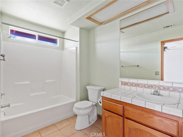 13951 Falling Leaf Rd, Apple Valley, CA 92307 - full bath with toilet, vanity, tile patterned flooring, washtub / shower combination, and a textured ceiling