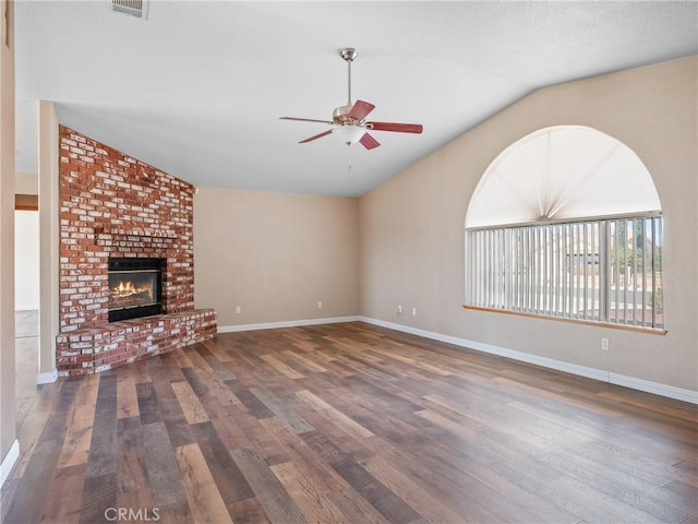 13951 Falling Leaf Rd, Apple Valley, CA 92307 - unfurnished living room with vaulted ceiling, a ceiling fan, wood finished floors, baseboards, and a fireplace