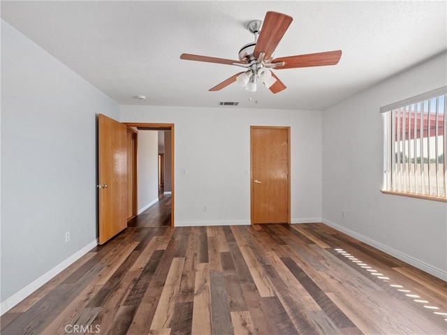 13951 Falling Leaf Rd, Apple Valley, CA 92307 - unfurnished bedroom featuring baseboards, dark wood finished floors, and a ceiling fan