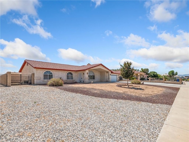 13951 Falling Leaf Rd, Apple Valley, CA 92307 - mediterranean / spanish home with a garage, a tile roof, concrete driveway, and stucco siding