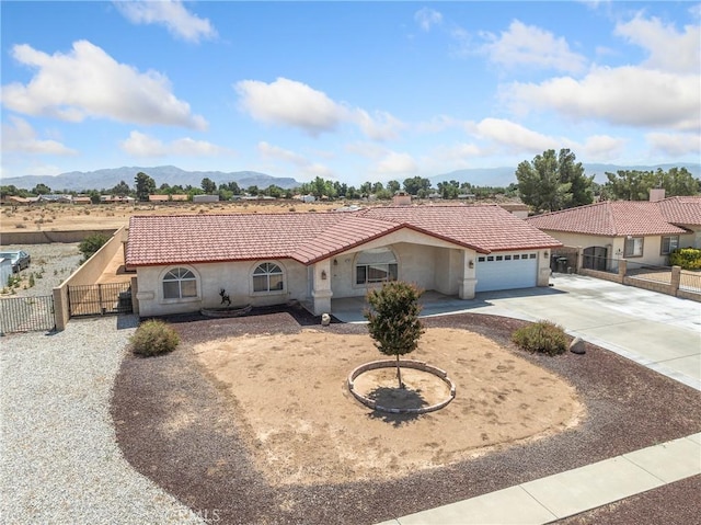 13951 Falling Leaf Rd, Apple Valley, CA 92307 - mediterranean / spanish house featuring driveway, stucco siding, a garage, and a tiled roof