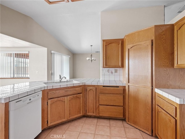13951 Falling Leaf Rd, Apple Valley, CA 92307 - kitchen with white dishwasher, vaulted ceiling, a peninsula, a sink, and light tile patterned floors