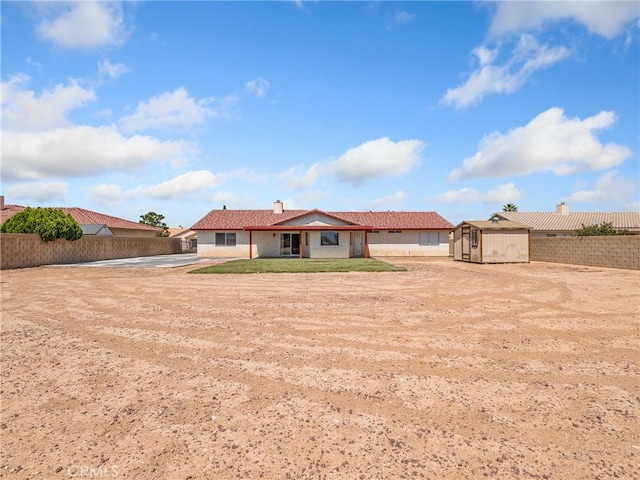 13951 Falling Leaf Rd, Apple Valley, CA 92307 - back of property with a fenced backyard, a patio, and a chimney