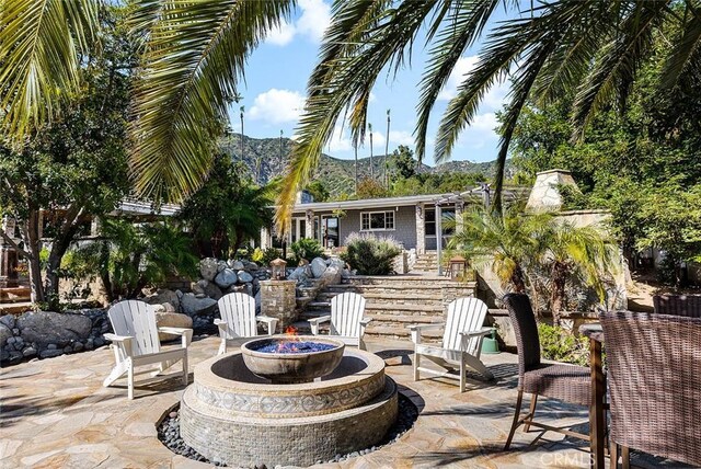 2212 Rim Rd, Duarte, CA 91008 - view of patio / terrace with an outdoor fire pit, a mountain view, and stairs