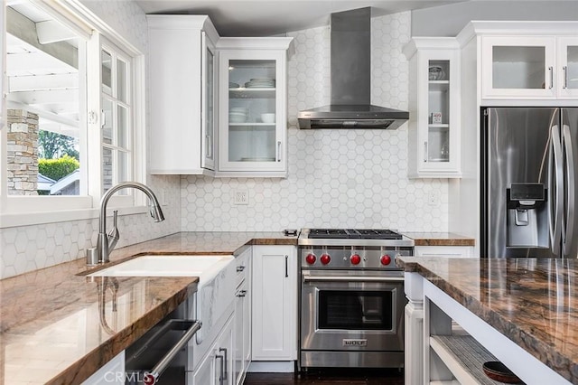 2212 Rim Rd, Duarte, CA 91008 - kitchen featuring wall chimney range hood, appliances with stainless steel finishes, backsplash, white cabinets, and dark stone counters