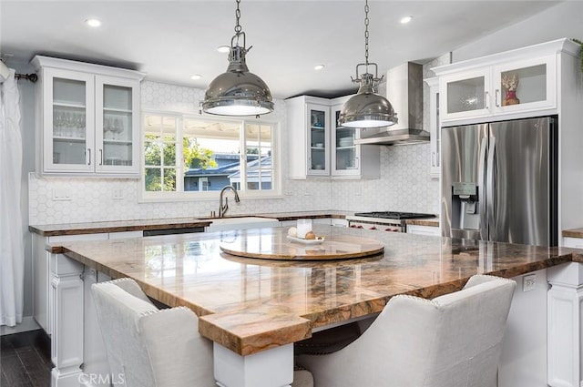 2212 Rim Rd, Duarte, CA 91008 - kitchen with stainless steel refrigerator with ice dispenser, wall chimney range hood, white cabinets, tasteful backsplash, and recessed lighting