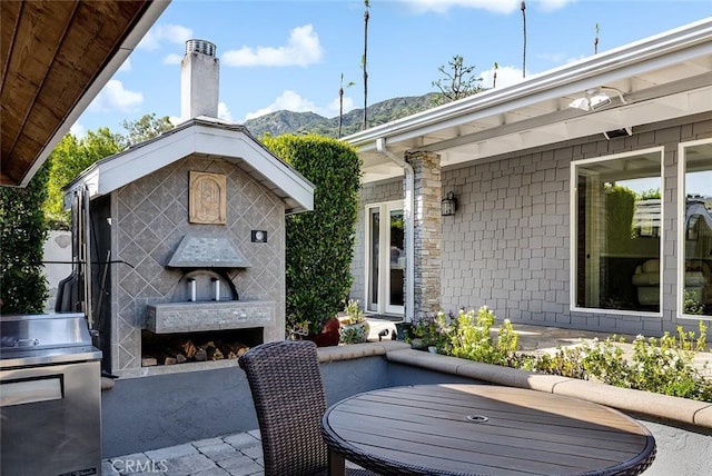 2212 Rim Rd, Duarte, CA 91008 - view of patio with exterior fireplace, a grill, and a mountain view