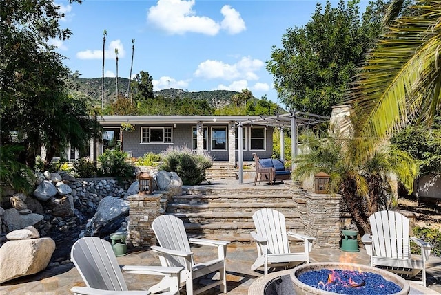 2212 Rim Rd, Duarte, CA 91008 - back of property with a fire pit, a patio, a mountain view, and a pergola