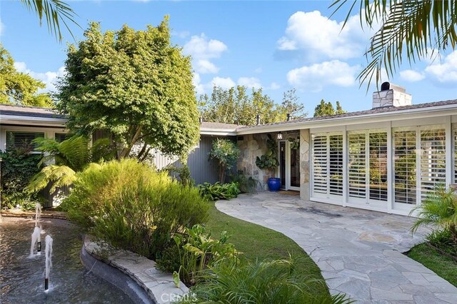 2212 Rim Rd, Duarte, CA 91008 - entrance to property with a patio, a chimney, and stone siding