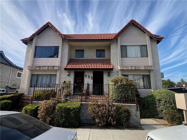 333 S Arroyo Dr Unit J, San Gabriel, CA 91776 - view of front facade with a tiled roof, covered porch, and stucco siding