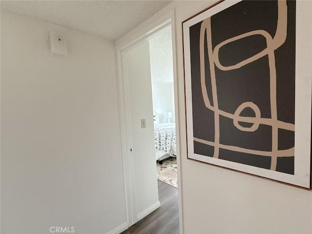 333 S Arroyo Dr Unit J, San Gabriel, CA 91776 - corridor with dark wood-style floors, baseboards, and a textured ceiling
