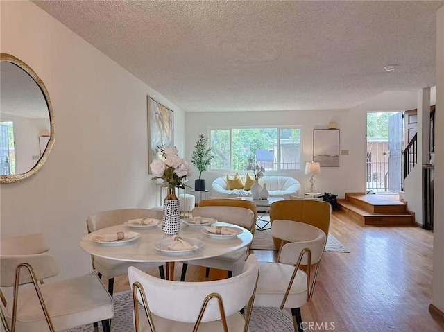 333 S Arroyo Dr Unit J, San Gabriel, CA 91776 - dining space with a textured ceiling, healthy amount of natural light, and wood finished floors