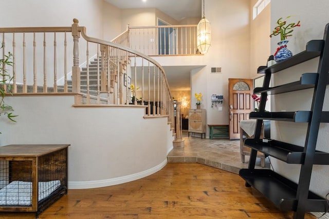 1394 Corte Magna, Oceanside, CA 92057 - staircase featuring wood finished floors, a towering ceiling, and baseboards