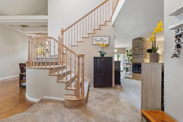 1394 Corte Magna, Oceanside, CA 92057 - stairs with baseboards, a multi sided fireplace, wood finished floors, and a towering ceiling