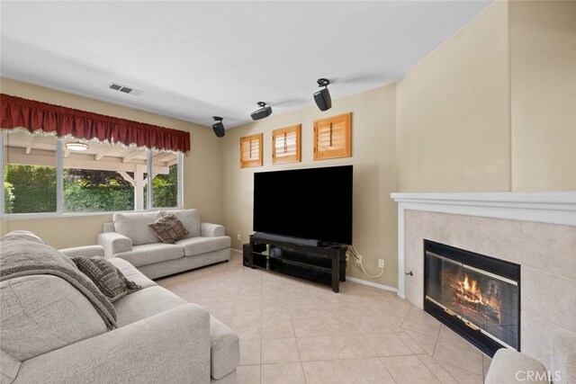 4616 W W Ave J2, Lancaster, CA 93536 - living area with light tile patterned flooring, a tiled fireplace, and baseboards