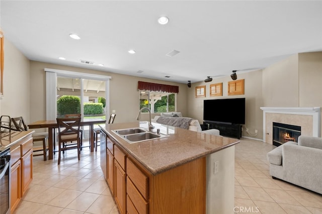 4616 W W Ave J2, Lancaster, CA 93536 - kitchen featuring a sink, light tile patterned floors, a fireplace, open floor plan, and recessed lighting