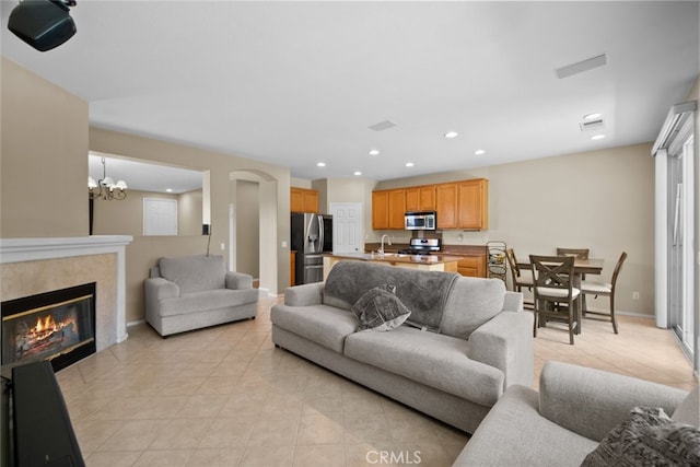 4616 W W Ave J2, Lancaster, CA 93536 - living area featuring light tile patterned floors, recessed lighting, a chandelier, a tiled fireplace, and baseboards